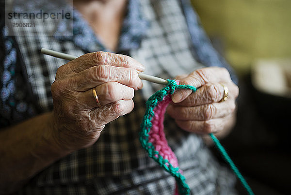 Hands of senior woman crocheting  close-up