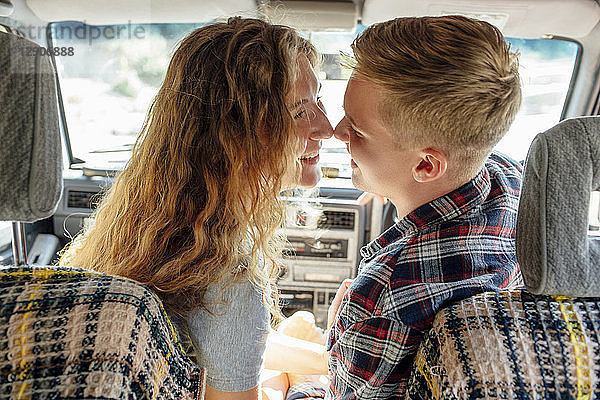 Romantic couple doing road trip  kissing in car