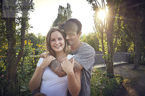 Happy young couple flirting in a park in summer