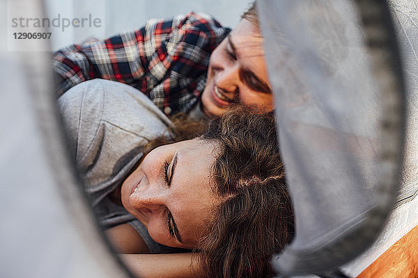 Happy couple resting in a tent