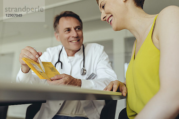 Woman discussing teatment with her doctor