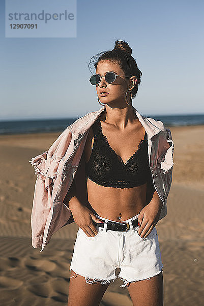 Portrait of fashionable teenage girl on the beach