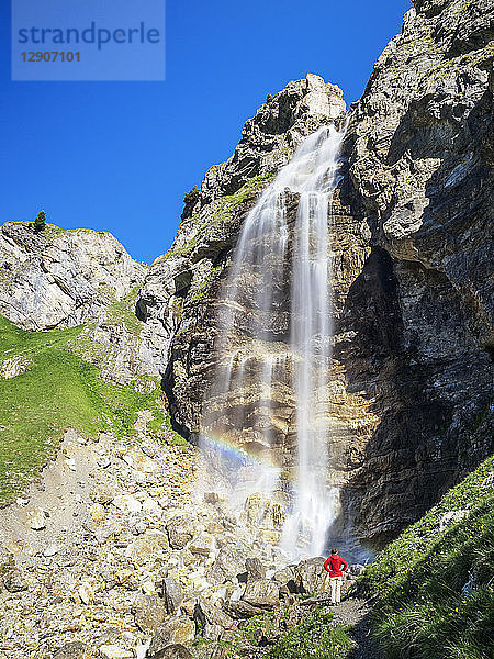 Italy  South Tyrol  hiker at waterfall on path towards Schlinig Pass