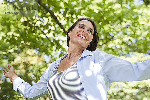 Portrait of relaxed mature woman dancing in nature