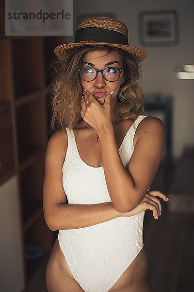 Portrait of young woman wearing a swimsuit and glasses  indoor