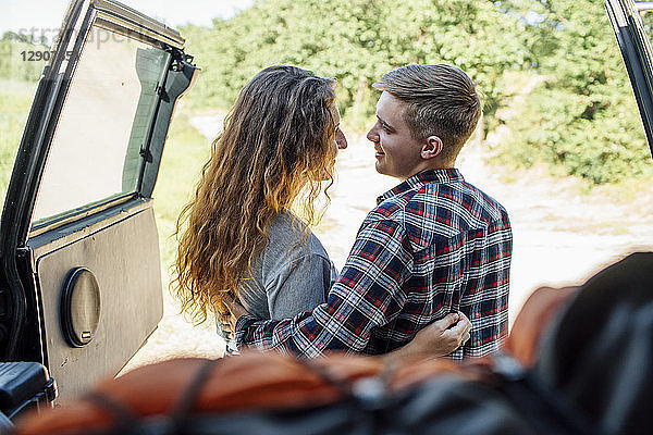 Romantic couple doing road trip  embracing