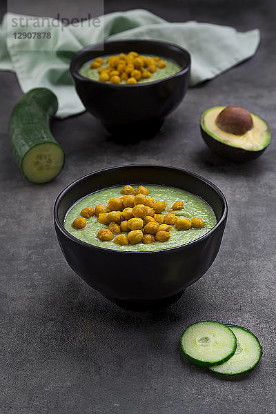 Bowl of green gazpacho with avocado and curcuma roasted chick peas