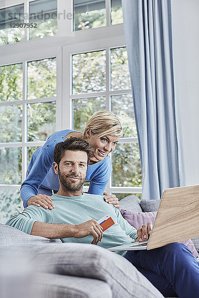 Portrait of couple at home shopping online