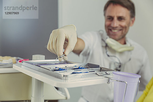 Dentist using dental instruments for treatment