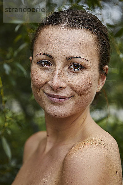 Portrait of freckled young woman in nature