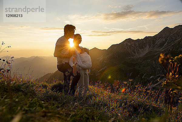 Germany  Bavaria  Oberstdorf  family with little daughter on a hike in the mountains at sunset