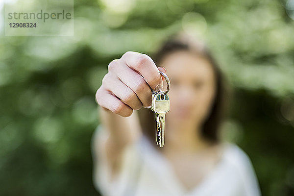 Close-up of woman holding key