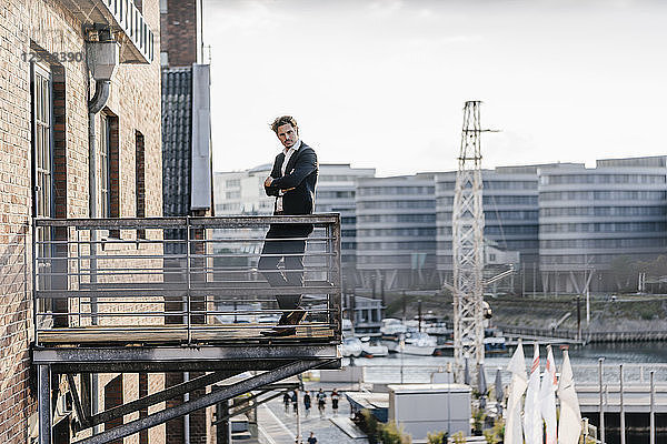 Pensive businessman standing on balcony