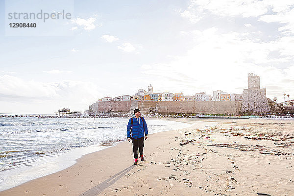 Italy  Molise  Termoli  young man walking at the beach