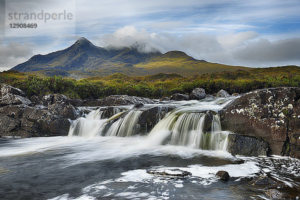 United Kingdom  Scotland  Scottish Highlands  Isle Of Skye  Waterfall at Sligachan river with view to the Cuillin mountains