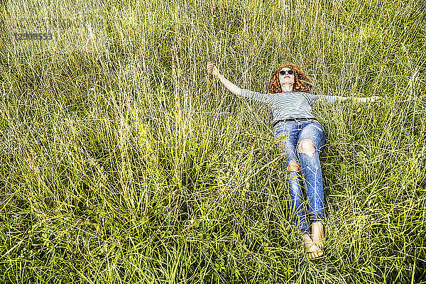 Young woman relaxing on a meadow