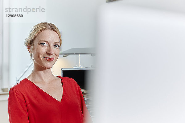 Portrait of smiling young woman in office