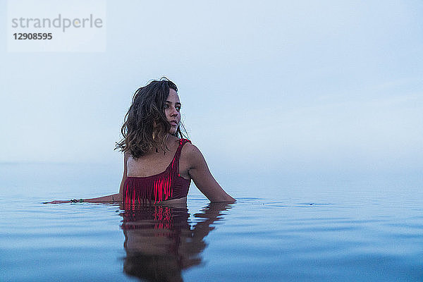 Woman wearing bikini  standing in water of a lake