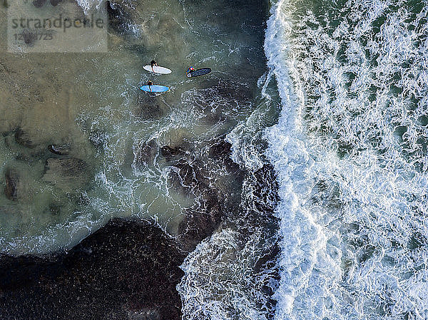 Indonesia  Bali  Aerial view of Dreamland beach  three surfers from above