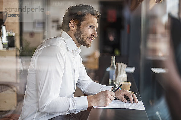 Businessman in a cafe taking notes
