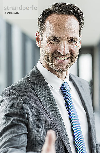 Portrait of smiling businessman shaking hands