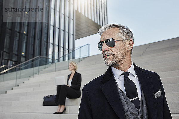 Portrait of fashionable mature businessman wearing sunglasses