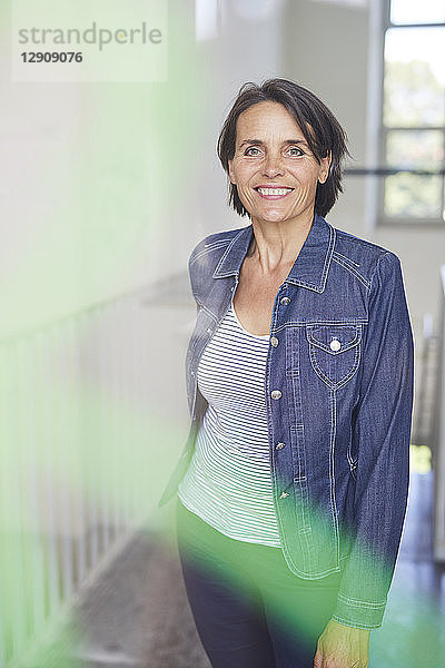 Portrait of smiling mature woman wearing denim shirt