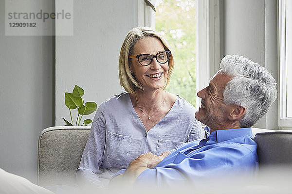 Happy mature couple on couch at home