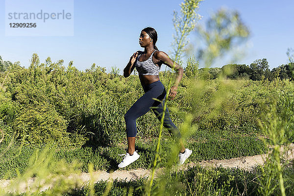 Young athlete jogging in the fields