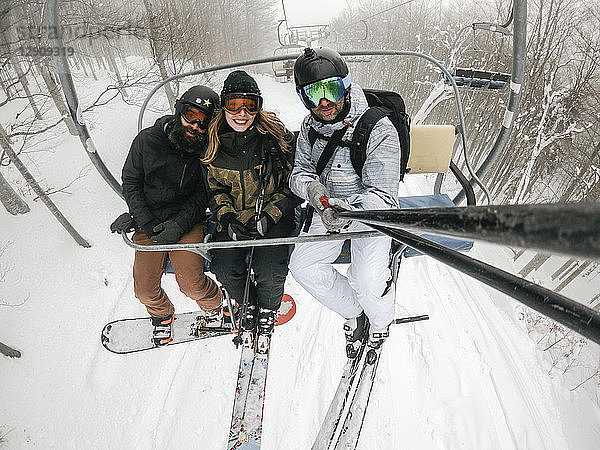 Italy  Modena  Cimone  portrait of happy friends taking a selfie in a ski lift