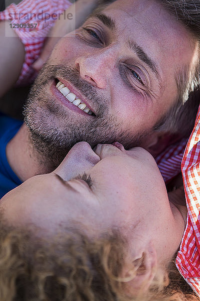 Happy affectionate couple lying down