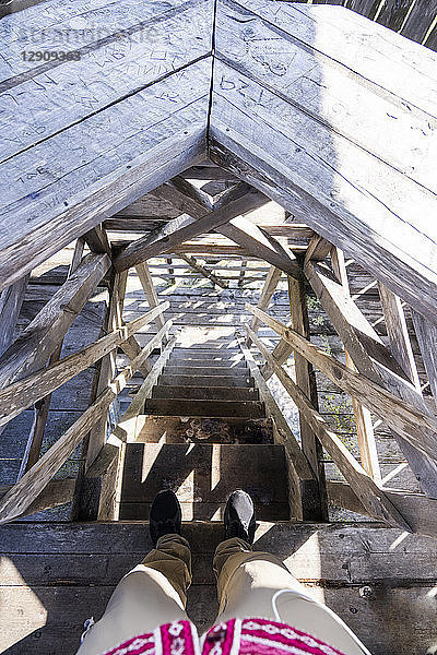 Finland  Feet of man standing at steep wooden stairs