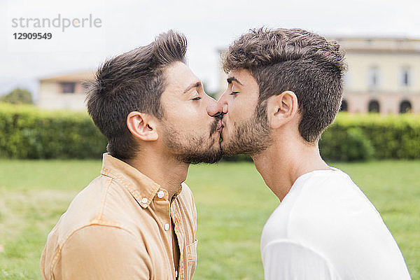 Kissing young gay couple