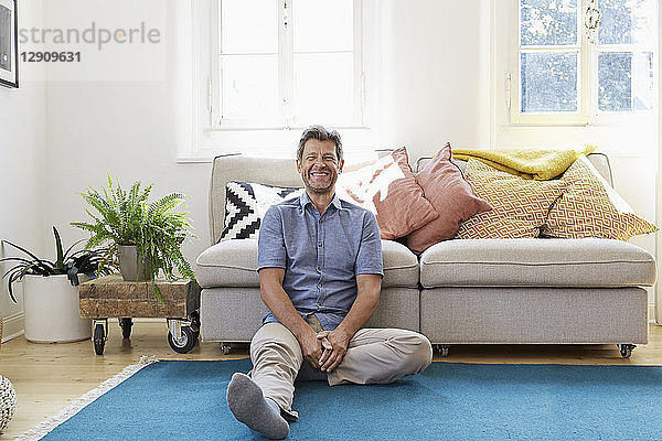 Man sitting at home  looking happy