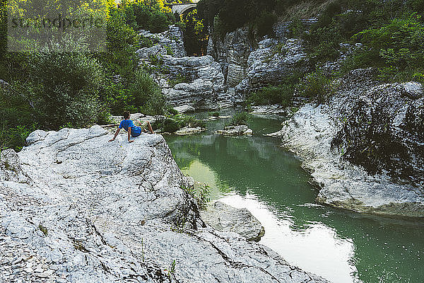 Italy  Marche  Fossombrone  Marmitte dei Giganti canyon  Metauro river  hiker sitting on riverside