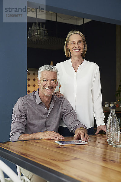 Portrait of smiling mature couple at home