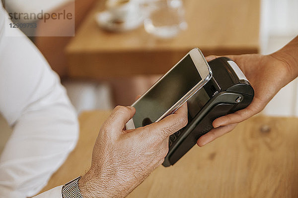 Contactless payment with smartphone in cafe