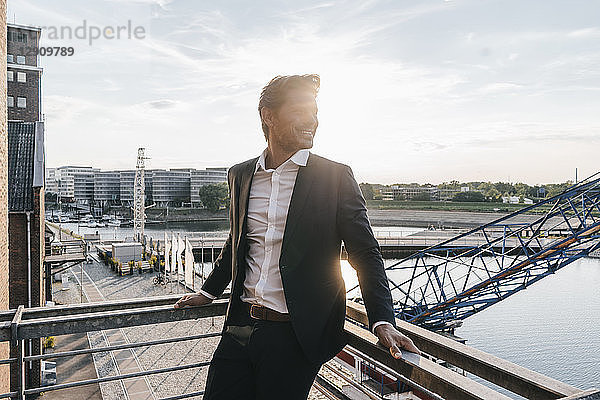 Successful businessman standing on balcony