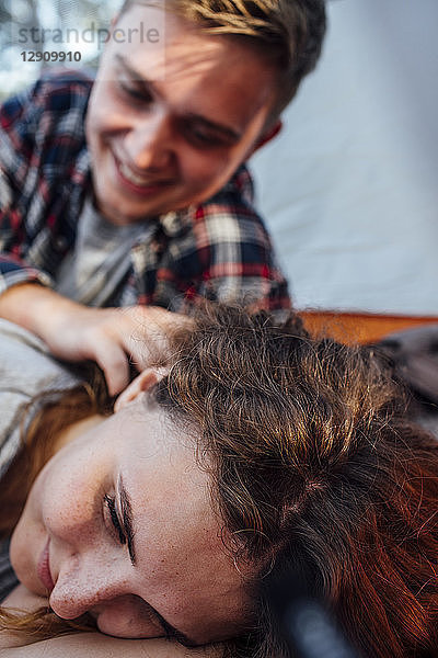 Happy couple resting in a tent