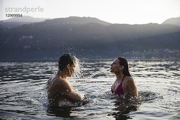 Young couple having fun in a lake