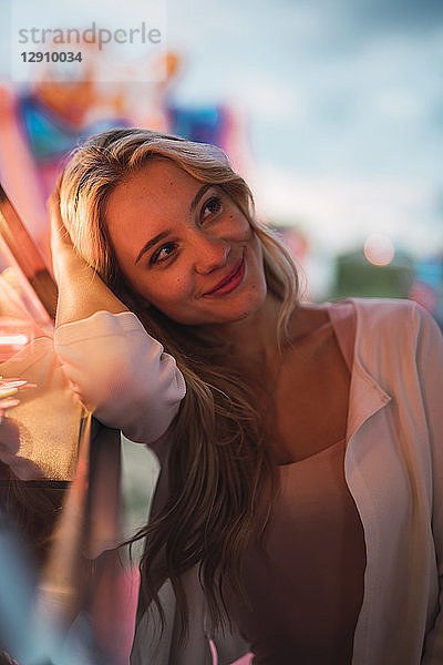 Portrait of smiling young woman on a funfair