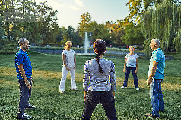 Group of people doing Tai chi in a park