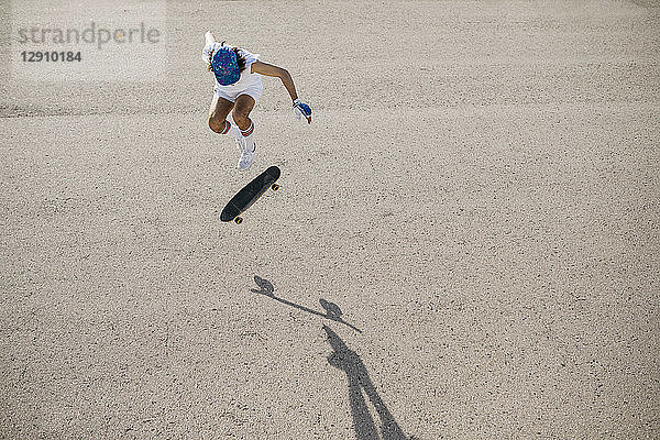 From above shot of sportive man riding skateboard