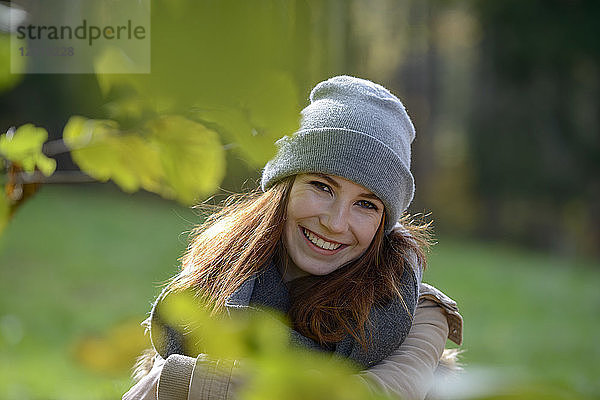 Portrait of smiling teenage girl in autumnal forest