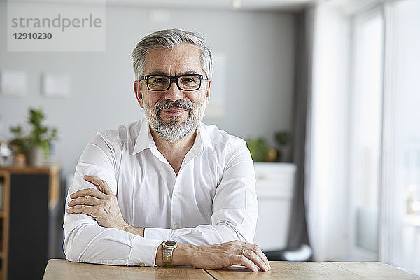 Portrait of content mature man at home