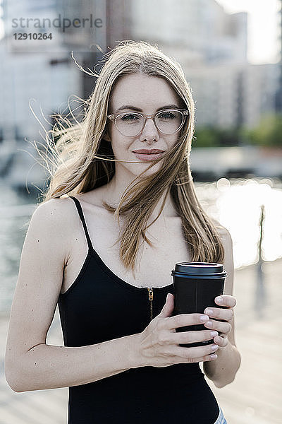 Young woman holding cup of coffee