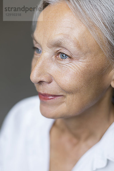 Half profile of blue eyed senior woman