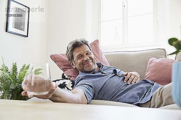 Man relaxing at home  drinking water