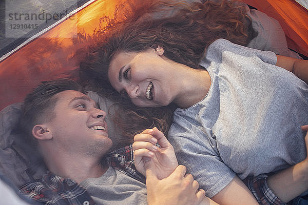 Happy couple resting in a tent