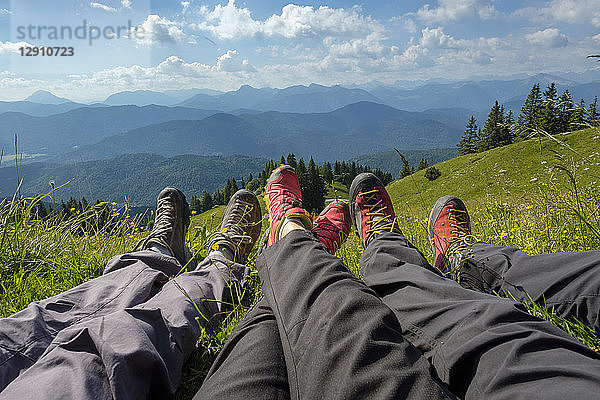 Germany  Bavaria  Brauneck near Lenggries  legs of hikers in meadow in alpine landscape